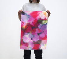 Load image into Gallery viewer, A person holding a colorful abstract patterned tea towel.